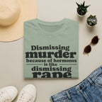 Statement Tee — "Dismissing m because of hormones is like dismissing r because of testosterone"