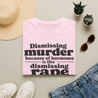 Statement Tee — "Dismissing m because of hormones is like dismissing r because of testosterone"